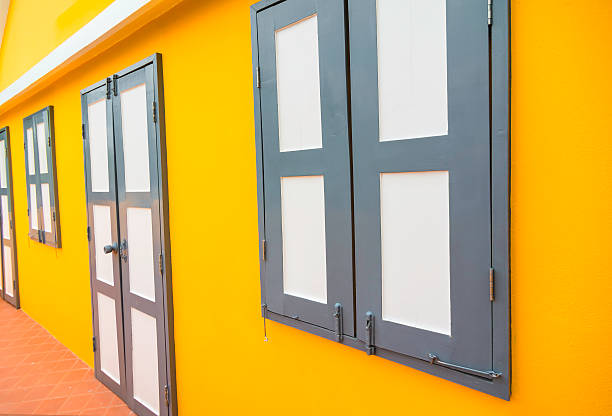 istock Window and door on the yellow wall. 616903000