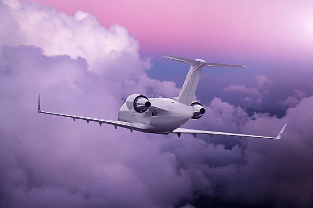istock Airplane flying at purple sunset over clouds 616903126