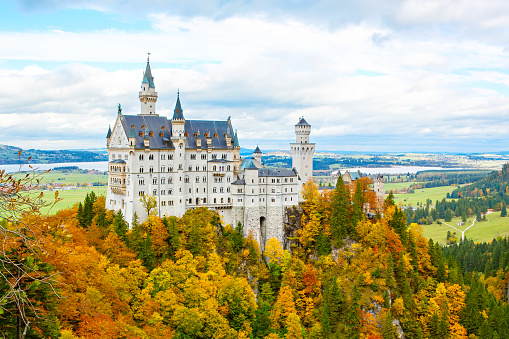 Neuschwanstein, Germany - October 19, 2016: Neuschwanstein Castle, Germany. Image of the famous tourist attraction surrounded with autumn colors during fall.