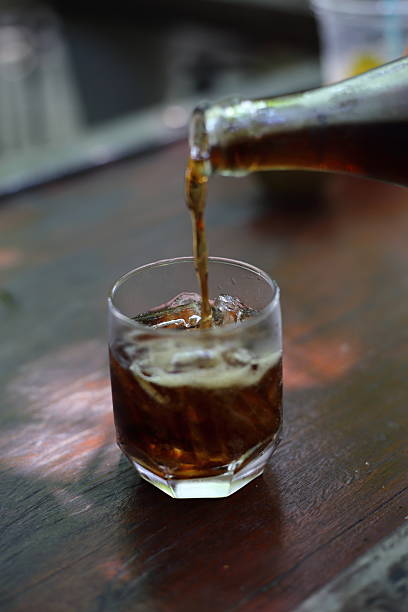 istock Pouring cola into the glass 616903220