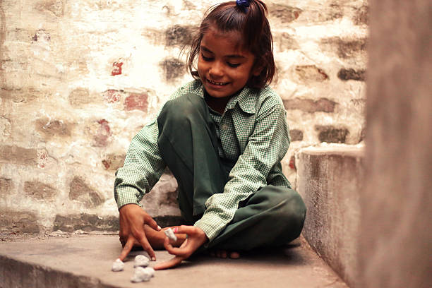 istock Little girl playing with pebble 616903910