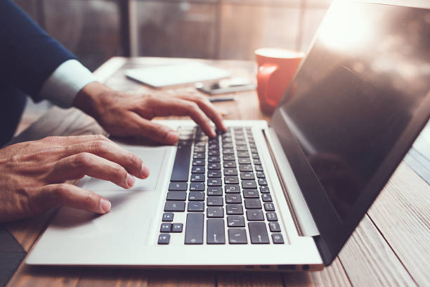 istock Male hands typing. Modern laptop on desk 616908344