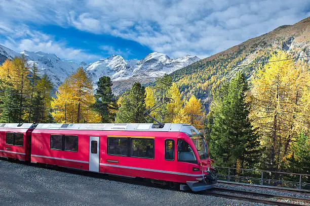 Swiss mountain train Bernina Express crossed Alps with glaciers in autumn
