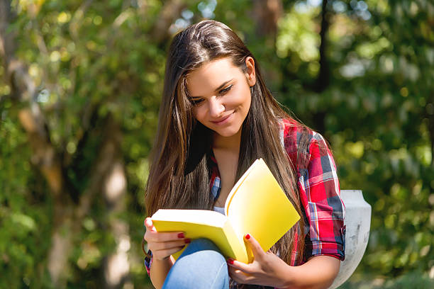 istock Student girl studying in the park 617354422