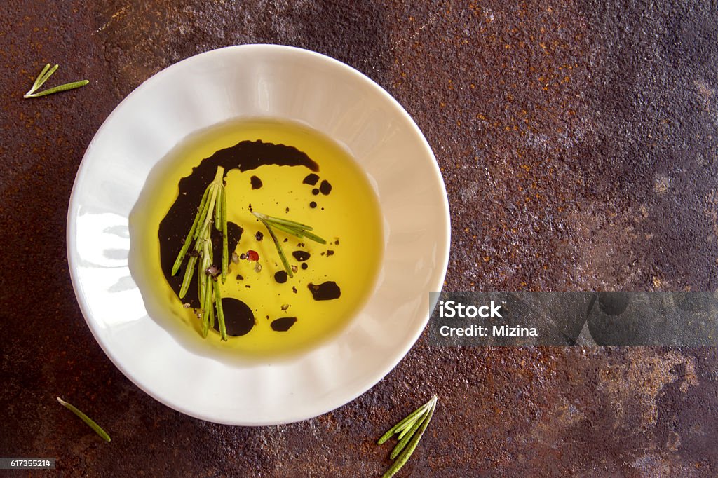 olive oil with spices Organic olive oil with rosemary, balsamic vinegar and spices over rustic metal background with copy space, healthy food concept Balsamic Vinegar Stock Photo