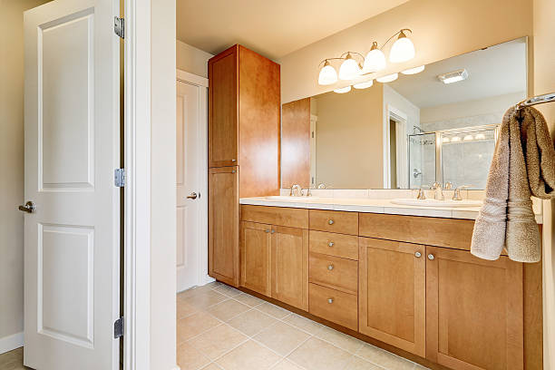 istock View of bathroom storage units, two sinks and large mirror 617356174