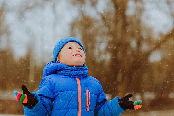 istock little boy enjoy snow in winter nature 617356304