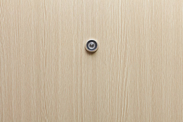 Lens peephole on new wooden door Lens peephole on new wooden door peep hole stock pictures, royalty-free photos & images