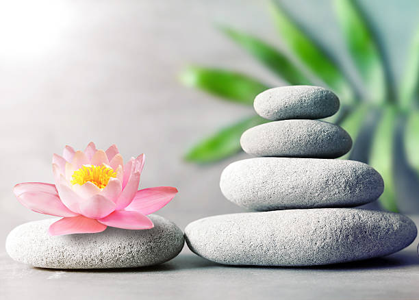 istock Spa stones with flower lily on light background 617356994