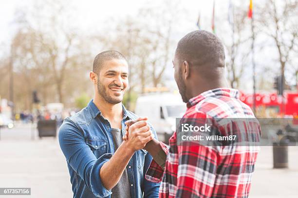 Two Men Giving A Friendly Handshake Stock Photo - Download Image Now - Friendship, Two People, Only Men