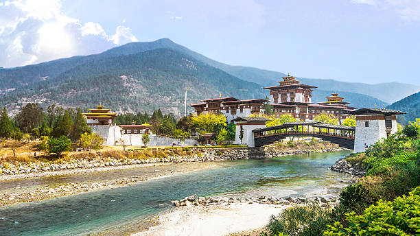 The Punakha Dzong Monastery and bridge across the river The Punakha Dzong Monastery and bridge across the river in Bhutan Asia one of the largest monestary in Asia with the landscape and mountains background, Punakha,Bhutan monastery religion spirituality river stock pictures, royalty-free photos & images