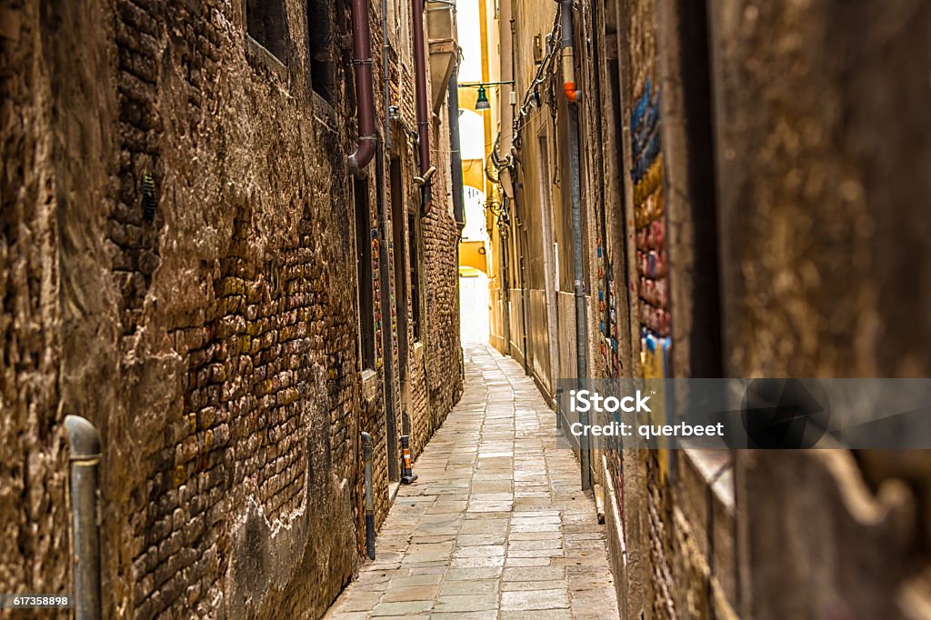 Old narrow alley in Venice Narrow Stock Photo