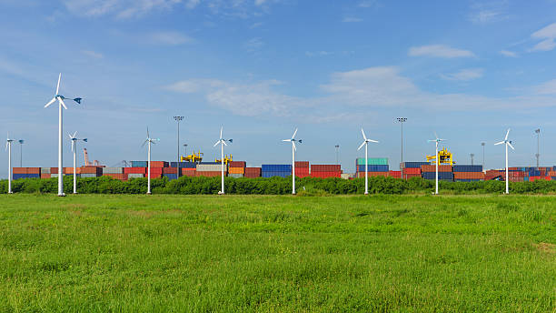 istock Cargo ship in port filled container, with wind turbines 617359004