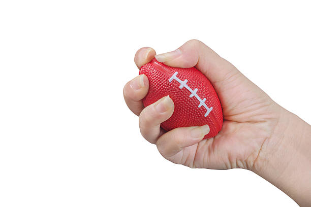 istock Hand squeezing stress ball ,woman 617360106