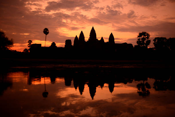 shadow of Angkor Wat central sanctuary and rising sun