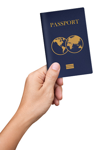 Pasaporte azul de la mano aislado sobre fondo blanco photo
