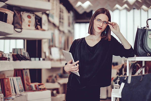 istock Young businesswoman is working in her store 617363796