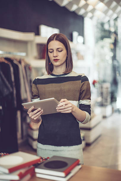 istock Young businesswoman is working in her store 617365510
