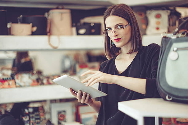 istock Young businesswoman is working in her store 617365606