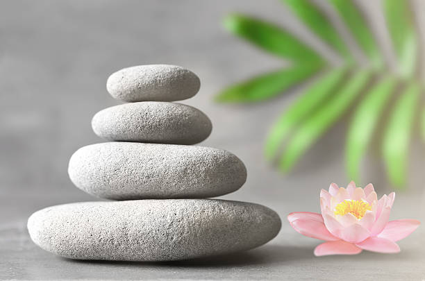 istock Spa stones with flower lily on light background 617366012