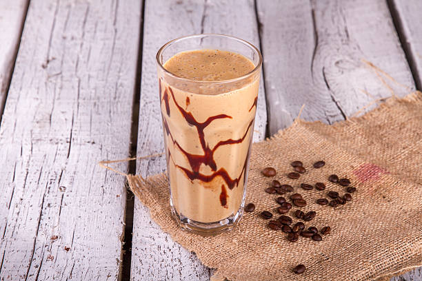 istock Cold chocolate milkshake frappe in tall glass with ice 617366814