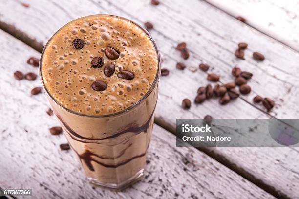 Cold Chocolate Milkshake Frappe In Tall Glass With Ice Stock Photo - Download Image Now