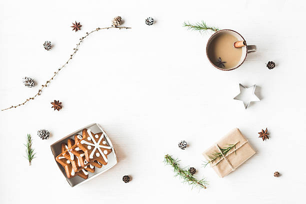 Cup of coffee, gift, larch branches, cinnamon sticks, christmas cookies