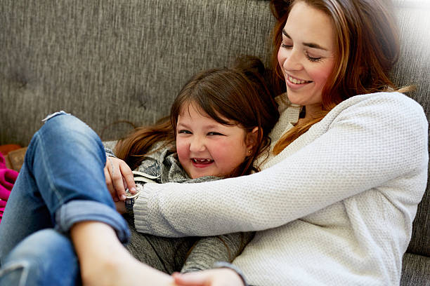 istock Cuddles on the couch with mommy 617368692