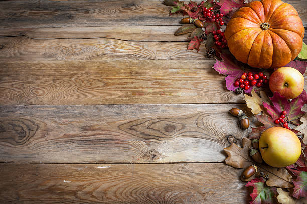 istock Thanksgiving or fall greeting with orange pumpkins, berries and 617371324