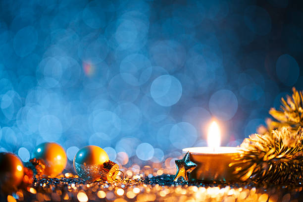istock Lighted candle and christmas decorations on defocused blue background 617371770
