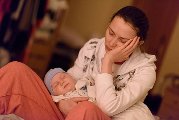 istock tired mother and sleeping baby 617374476