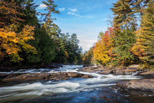 DSLR picture of a small river and waterfall waterfall in Autumn season. The riviere du Loup is a beautiful river in Mauricie, Quebec, Canada