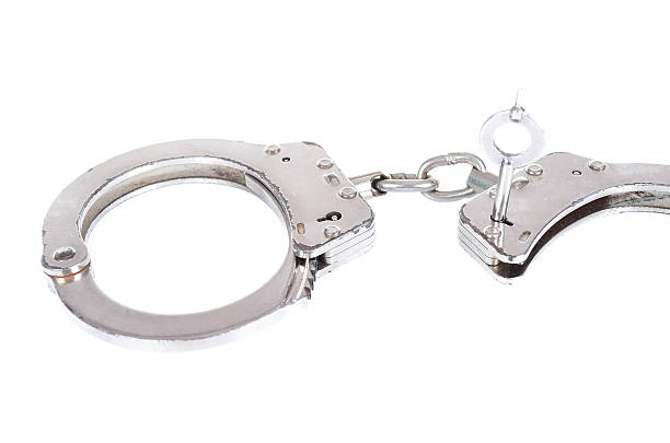 istock Pair of handcuffs isolated on a white background 617376900