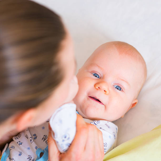 istock little baby and mum, close-up 617378078