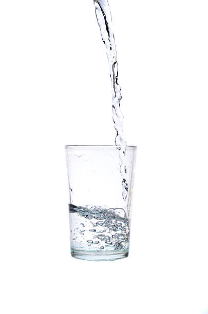 istock Fresh water pouring in a glass on white background 617378818