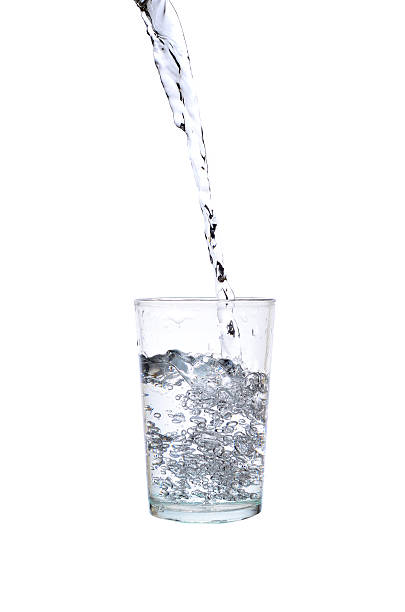 istock Fresh water pouring in a glass on white background 617379100