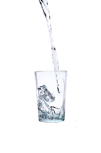 istock Fresh water pouring in a glass on white background 617379606