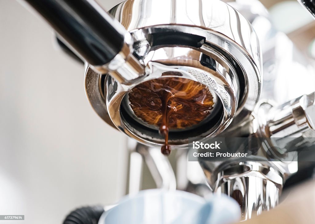 Delicious fresh morning espresso coffee Delicious fresh morning espresso coffee pouring through the bottomless portafilter Black Color Stock Photo