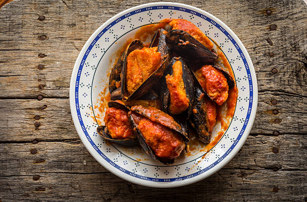 Traditional stuffed mussels with tomato sauce, typical from Puglia