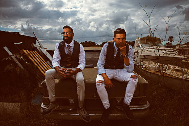istock Elegant men sitting on vintage car 617383208