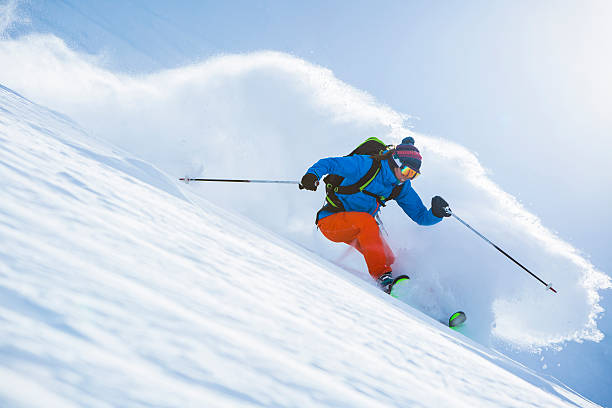 Female athlete skiing in deep powder. stock photo