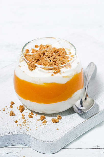 istock dessert with pumpkin, whipped cream and cookies, vertical 617386324