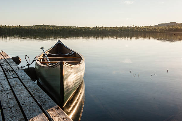 istock Rustic dock with canoe at sunset in Northern Maine 617386662