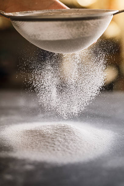 sifting flour stock photo