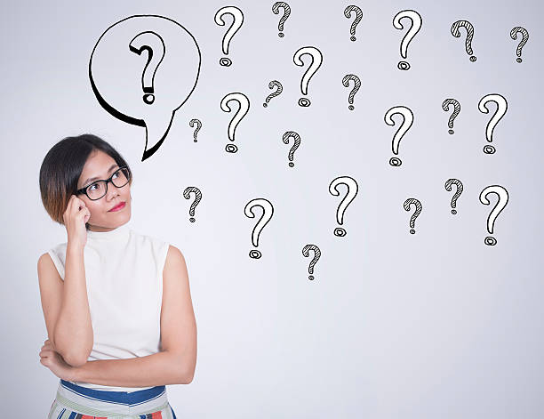 istock thinking business women with question mark on wall background 617387180