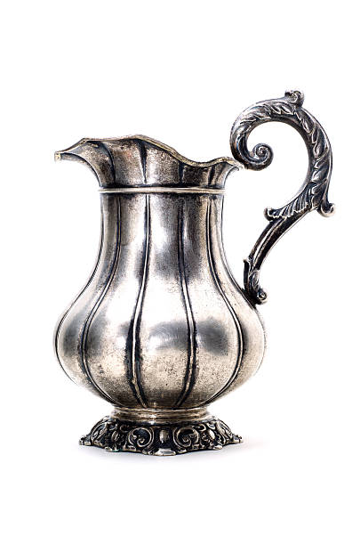istock Antique silver jug isolated on a white background. 617387662