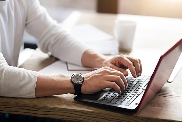 istock Close up of man typing on computer 617387690