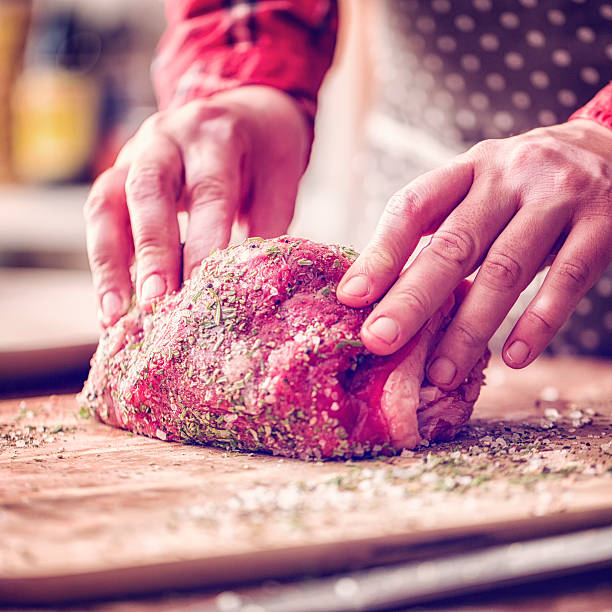 istock Rolling Fresh Roast Beef into Herbs and Spices 617388242