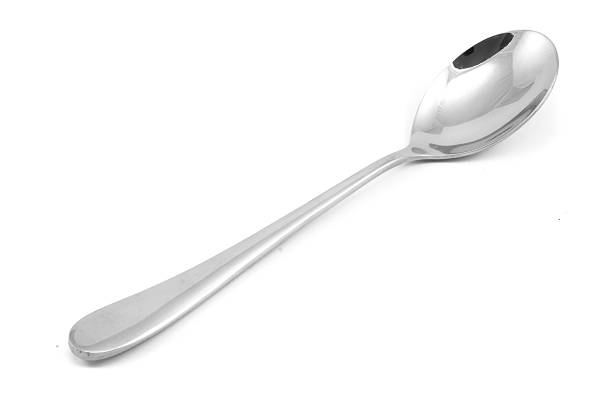 istock Stainless steel glossy metal kitchen spoon isolated 617388540