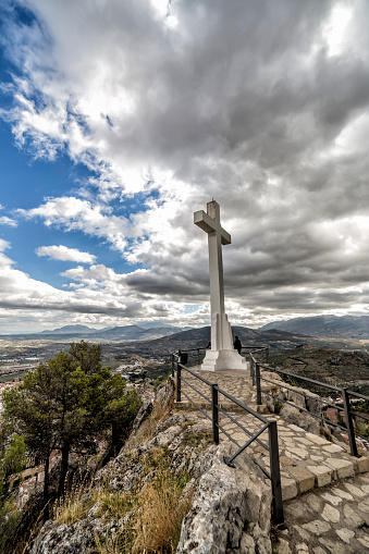 Landmark of walkway towards great crucifix in Santa Catalina or St Catherine mountain, public monument and lookout balcony over Jaen city, Andalusia, Spain